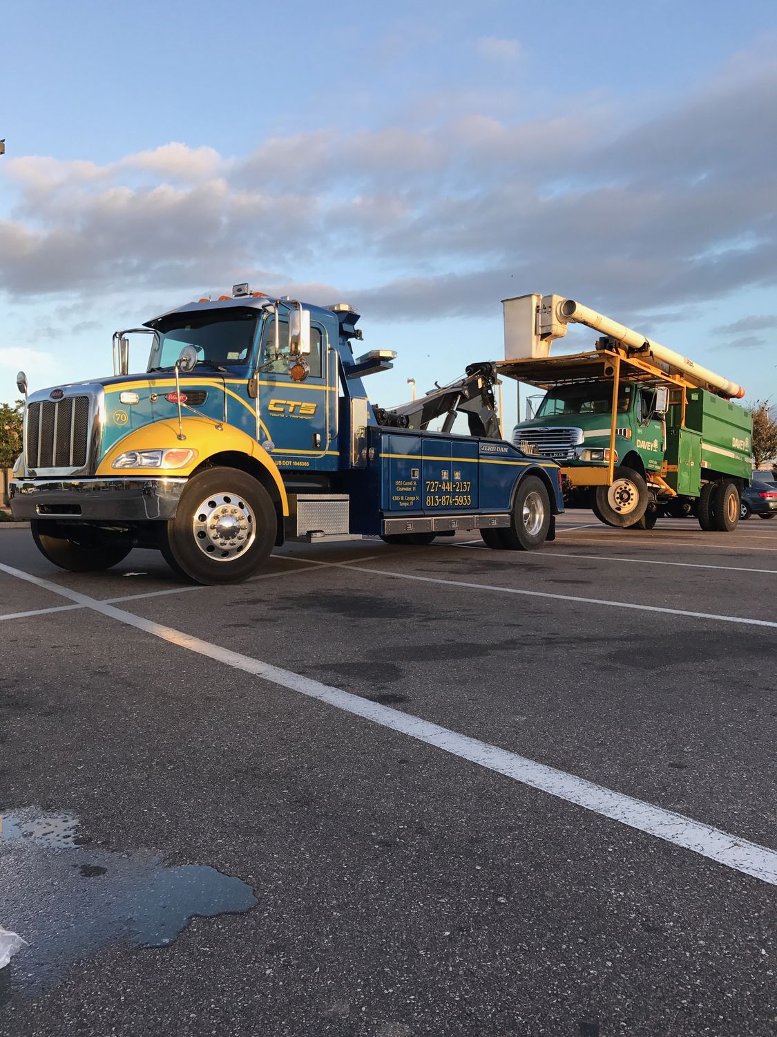 CTS wrecker towing a utility bucket truck