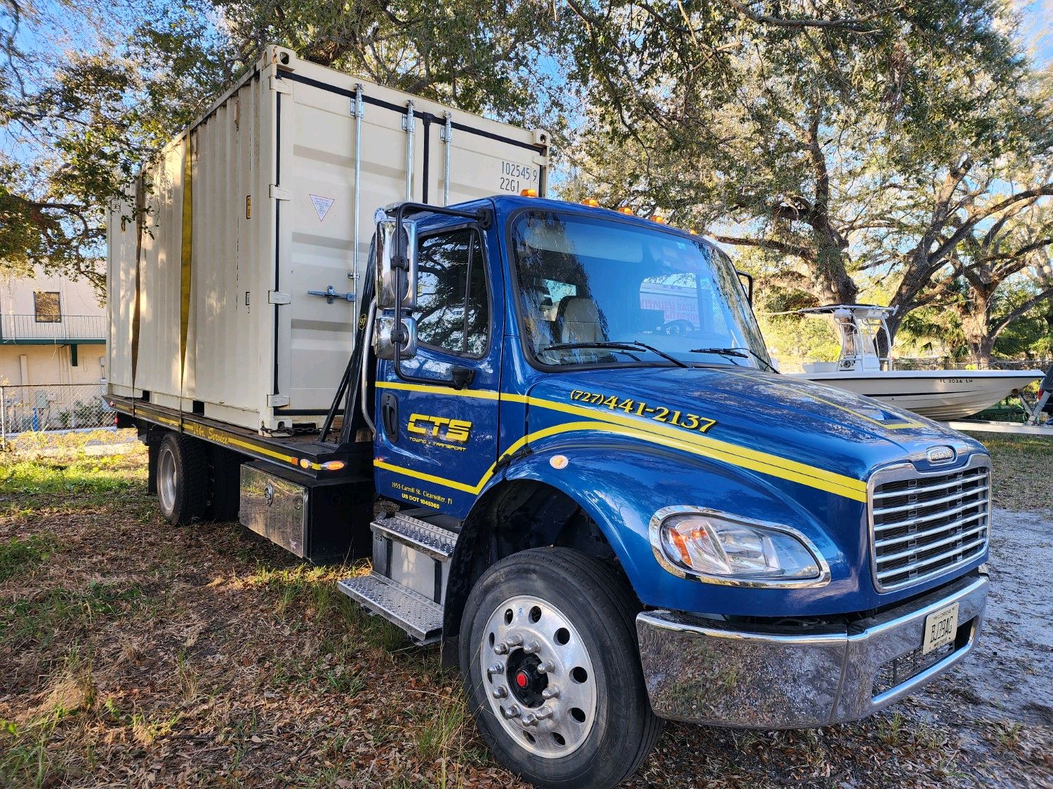 CTS rollback transporting a shipping container